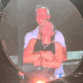 a man and a woman are hugging in front of a bubble with the letter m visible