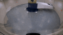 a white truck is being wrapped in plastic in a room
