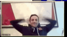 a man on a video call with his hands on his head