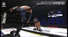 a man in a wrestling ring is kneeling down with a referee watching