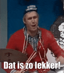 a man is playing drums with the words dat is zo lekker below him