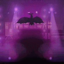 a woman is dancing on a stage with purple lights