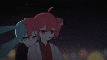 a couple of anime characters standing next to each other in the dark