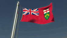 a red and white flag with a shield on it