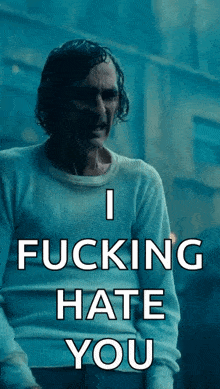 a man in a white sweater with the words i fucking hate you on it