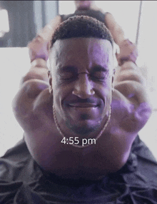 a man is laying on his back with his eyes closed and the time 4:55 pm