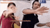 a man and a woman are dancing in front of a screen that says ' desitvforum.net exclusive '