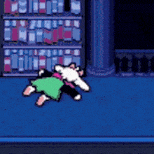 a cartoon character is laying on the floor in front of a book shelf