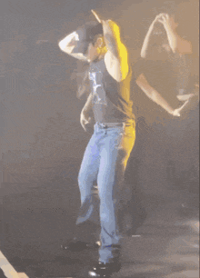 a man wearing a t-shirt that says lc is dancing on stage
