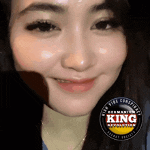 a close up of a woman 's face with a high vibe conspiracy king revolution logo behind her