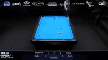 a pool table with a blue cloth and a diamond logo on it