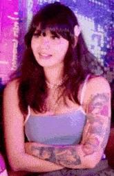 a woman with a tattoo on her arm is smiling