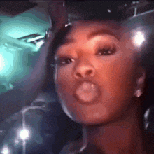 a close up of a woman blowing a bubble with her mouth open