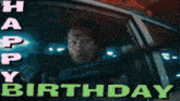 a man is driving a car with the words happy birthday behind him