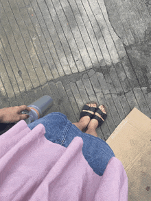 a person 's feet are on a cardboard box that says ' fragile ' on it