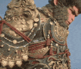 a statue of a man with a beard is wearing armor and looking down