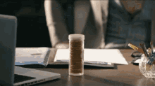 a bottle of cookies sits on a desk with a laptop