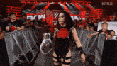 a woman is holding a trophy in front of a netflix logo