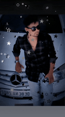 a man wearing sunglasses stands in front of a mercedes with a license plate that says jbs a038j0