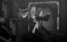 a black and white photo of two anime characters with the letter e on the bottom
