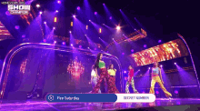 a group of women are performing on a stage with purple lights and the words show champion on the bottom