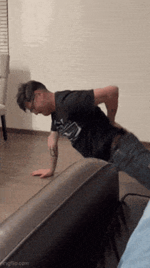 a man is doing push ups on a couch