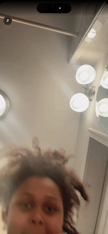 a person taking a picture of themselves in a bathroom mirror