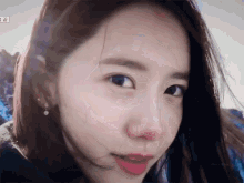 a close up of a woman 's face with a blurred background .