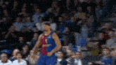 a blurred image of a basketball player in a blue jersey with the number 1 on it