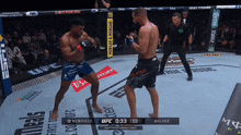 two men are fighting in an ufc ring with a referee