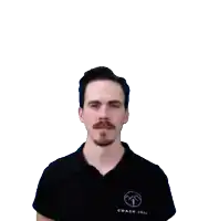 a man with a mustache and a black shirt looks at the camera