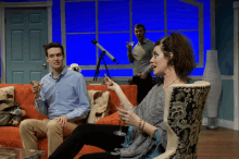 a man and a woman are sitting on a couch drinking champagne
