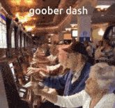 a group of people playing a slot machine with the words goober dash written above them