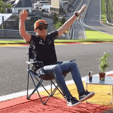 a man sitting in a chair with his arms outstretched
