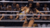 a woman in a wrestling ring with the word aew on the bottom left