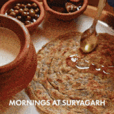 a plate of food with the words mornings at suryagarh below it