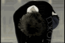 a person wearing a black shirt that says dx on the back