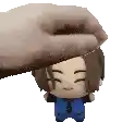 a hand is holding a stuffed toy on top of a stuffed toy .