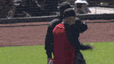 two men are walking on a baseball field with nbc sports bay area written on the screen