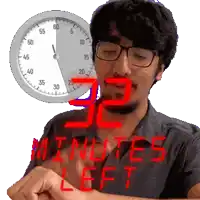 a man wearing glasses is looking at his watch with the words " minutes left " on the bottom