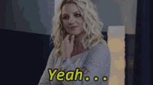 a woman with blonde hair is looking at the camera and says yeah .