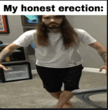 a man with long hair and a beard is standing in a room with the caption " my honest erection " above him