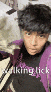 a young man in a purple jacket is holding a bunch of money in his hand