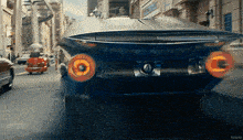 a blue car is driving down a city street and the word kepler is on the bottom right