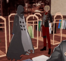 a man in red pants stands next to a man in a black robe