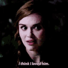 a close up of a woman 's face with the words `` i think i loved him '' written below her .