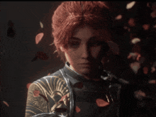 a woman with red hair is surrounded by petals