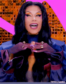 a woman with long black hair and rings on her fingers