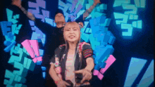 a man and a woman are dancing in front of a colorful background that says ' n ' on it