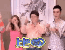 a group of people are dancing in front of a framed picture with chinese writing on it .